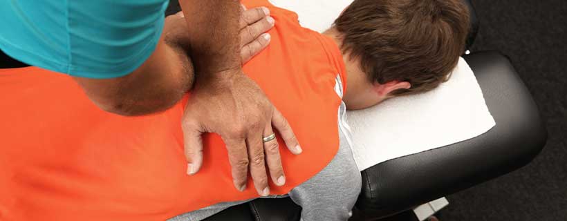 patient receiving drop table chiropractic in Erlanger for auto accident injury pain relief
